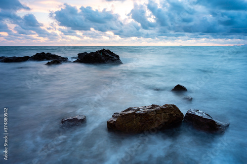 Sand beach among rocks on e...