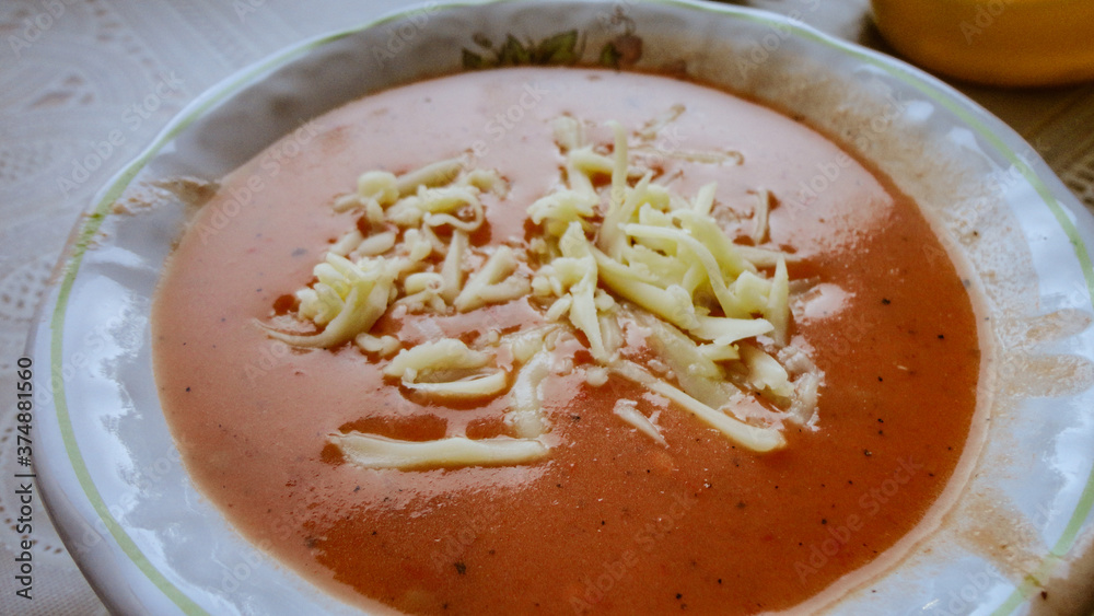 Fresh tomato soup with cheese in the white plate Fresh tomato soup with cheese in the white plate