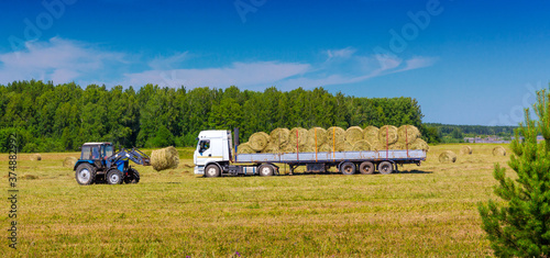 loading hay bales onto a truck