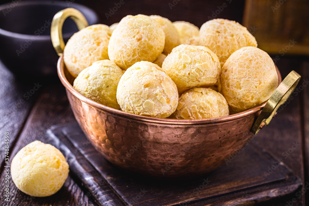Brazilian cheese bread, inside a copper metal pot, with punctual focus. Traditional food from the state of minas gerais. Brazilian cheese bread, inside a copper metal pot, with punctual focus. Traditional food from the state of minas gerais.