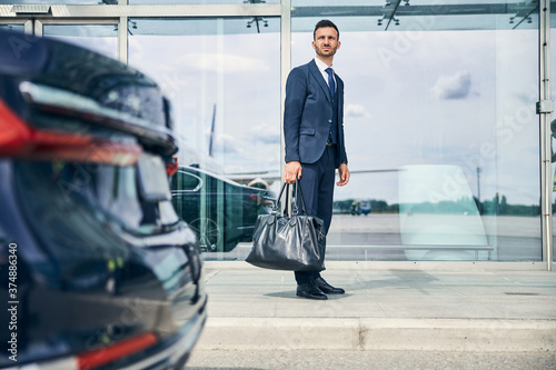 Elegant businessman waiting for a shuttle bus near the airport © Svitlana