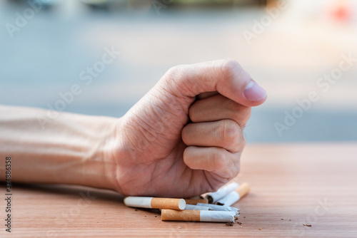 Human fist breaking cigarettes Anti smoking concept and Quit smoking.
