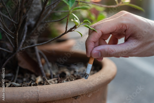 Stop smoking and Quit smoking cigarettes concept. Handsomeman holding broken cigarette in hands. Quit bad habit, health care concept.