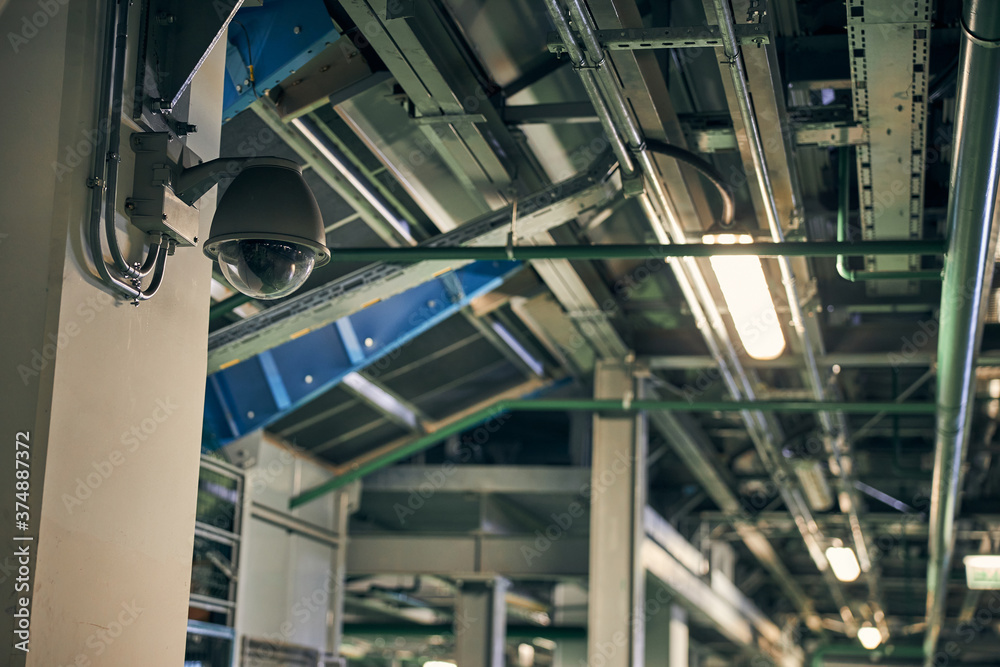 Security surveillance camera on a wall of a building Security surveillance camera on a wall of a building