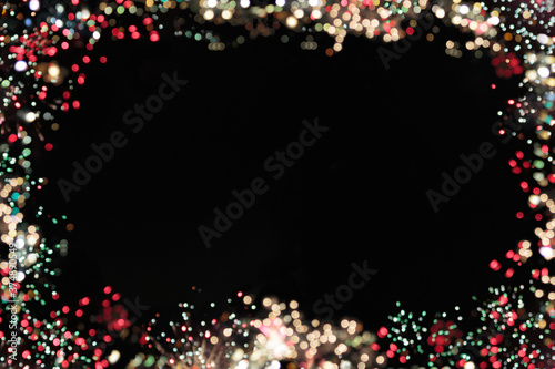 sparkly frame with bokeh effect lights in red, white and green around a black backgroundfor copy space, good for a holiday or Christmas theme or any celebration photo