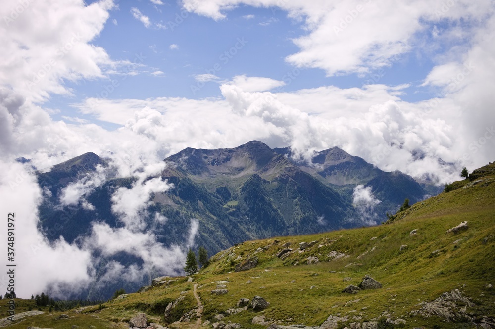 Cloudscape in the Alps with mountains in background (Peio, Trentino, Italy, Europe)