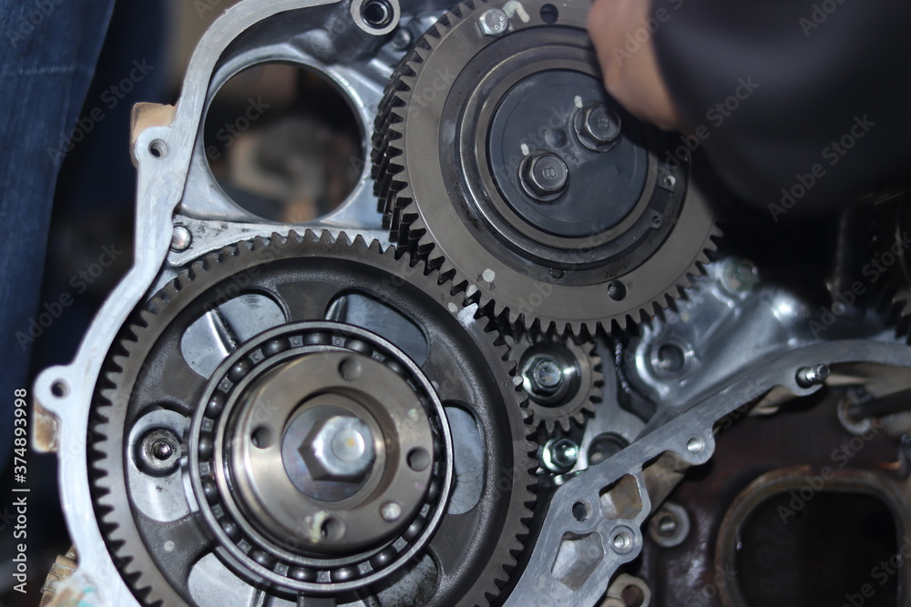 The mechanic is checking the engine. The mechanic is checking the engine.
