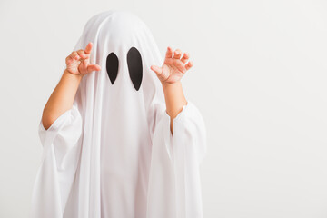 Funny Halloween Kid Concept, little cute child with white dressed costume halloween ghost scary, studio shot isolated on white background