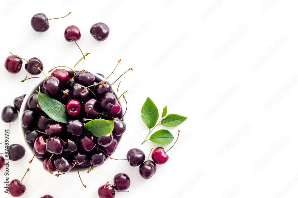 Plate of ripe red cherries with leaves, top view Plate of ripe red cherries with leaves, top view