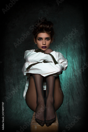 sexy girl with long legs in black tights and a white straitjacket.

