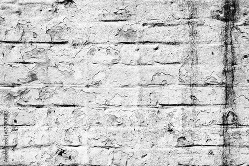 Texture of a brick wall with cracks and scratches which can be used as a background
