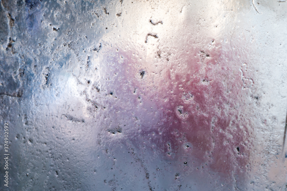 Abstract background of frosted pitted glass, with muted colors behind. Macro shot of old worn used glass, perfect for backgrounds and overlays. Abstract background of frosted pitted glass, with muted colors behind. Macro shot of old worn used glass, perfect for backgrounds and overlays.