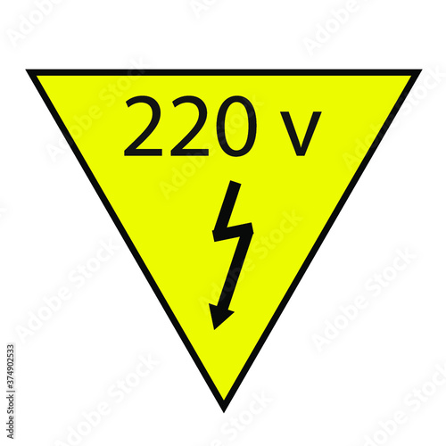 yellow sign with a black border and the inscription 220 volts