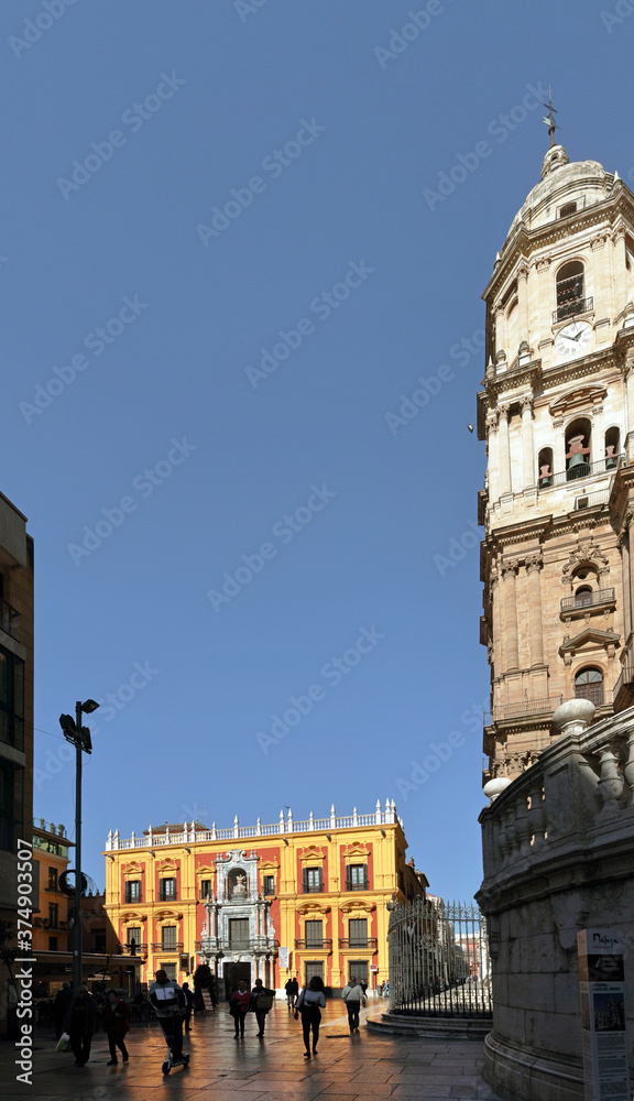 Malaga, Spain: restored, brightly coloured Episcopal Palace on Plaza Obispo in the old town of Malaga, diagonally accross the cathedral.