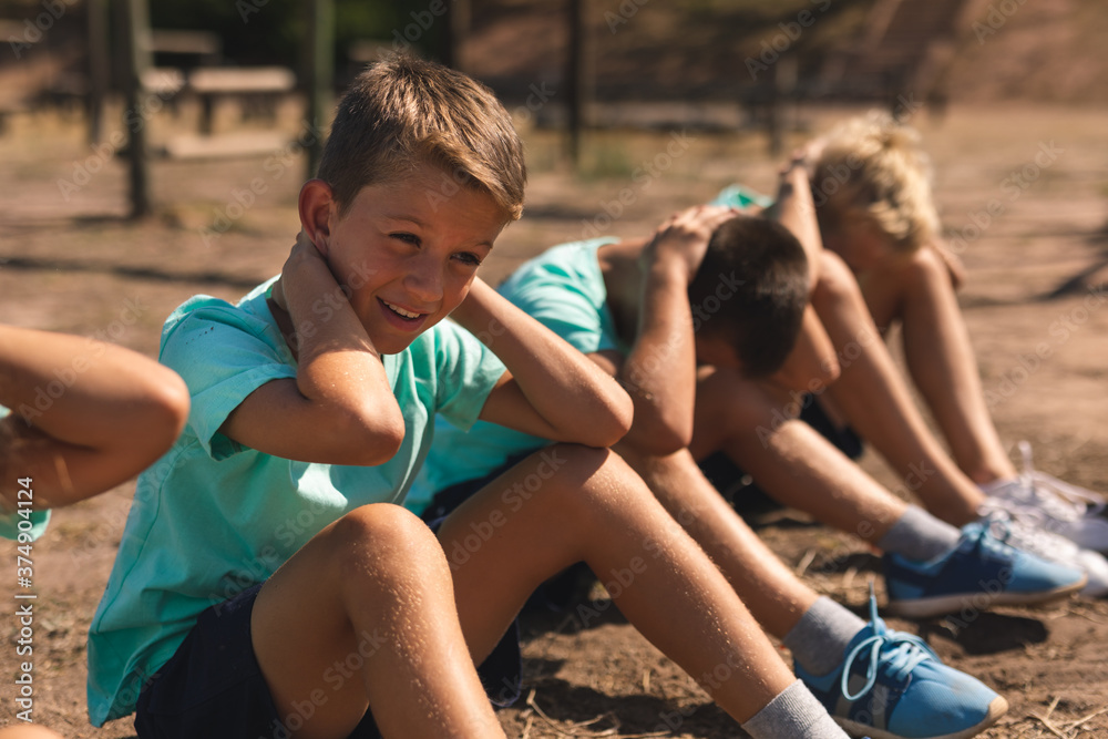 Group of boys performing sit ups at a bootcamp Group of boys performing sit ups at a bootcamp