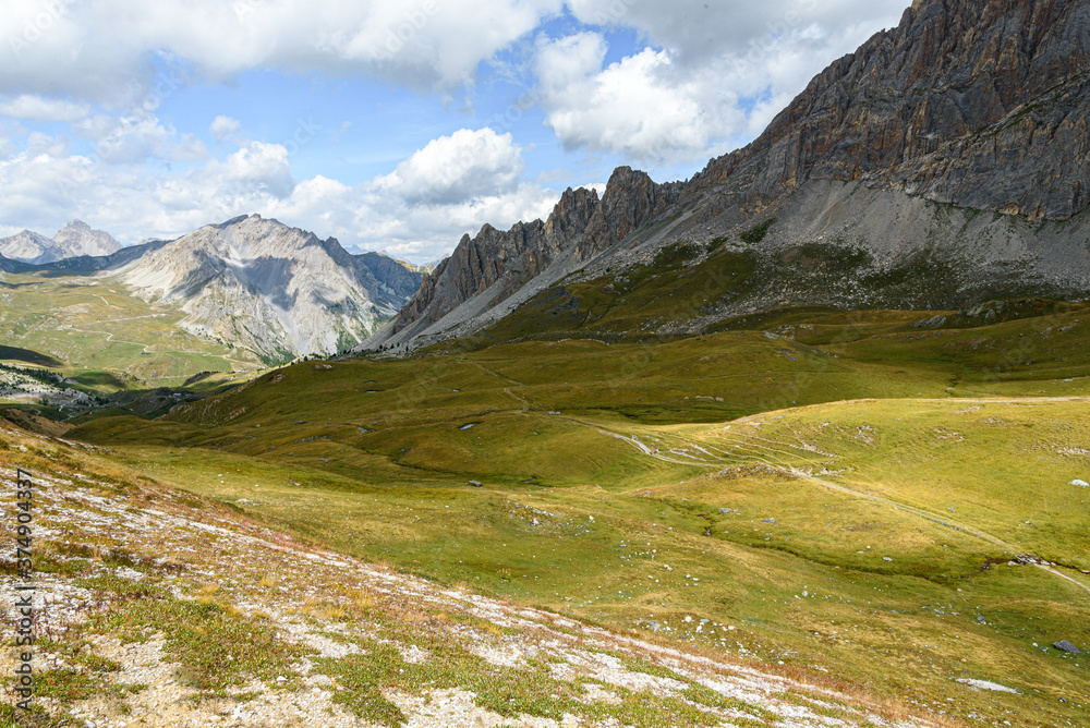 path in the valley, between the mountain peaks of the Alps, between the grass, ascending path path in the valley, between the mountain peaks of the Alps, between the grass, ascending path