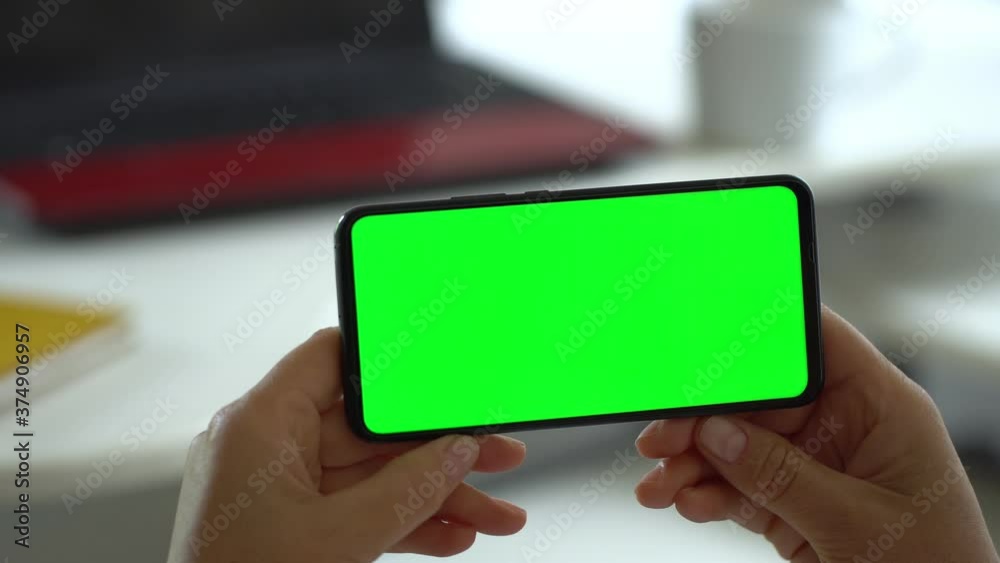 Handheld Camera: Point of View of Woman at Modern Room Sitting on a Chair Using Phone With Green Mock-up Screen Chroma Key Surfing Internet Watching Content Videos Blogs Handheld Camera: Point of View of Woman at Modern Room Sitting on a Chair Using Phone With Green Mock-up Screen Chroma Key Surfing Internet Watching Content Videos Blogs