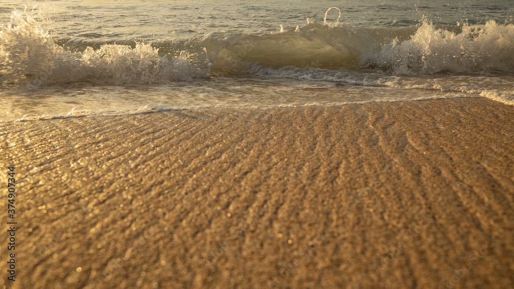 Fototapeta premium Scenic seascape. Milky foam waves at the beach. Sunset time. Waterscape for background. Selected soft art focus. Sunlight reflection on the water and sand. Balangan beach, Bali, Indonesia