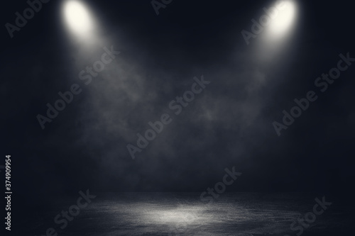 Empty space of Studio dark room concrete floor grunge texture background with spotlight and white smoke. © Angkana