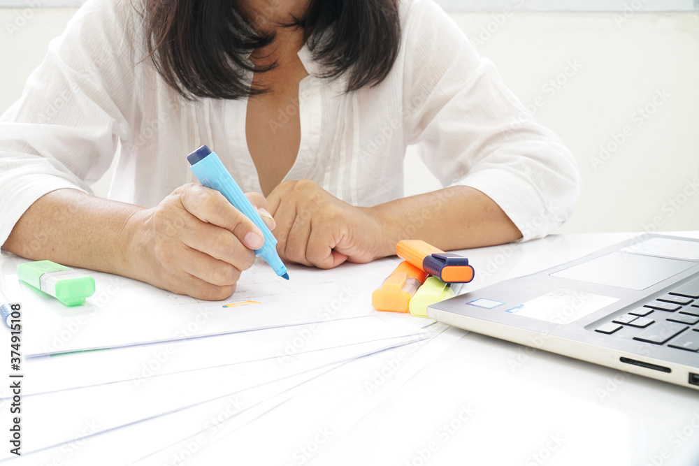 A woman wearing a white shirt Checking documents A woman wearing a white shirt Checking documents