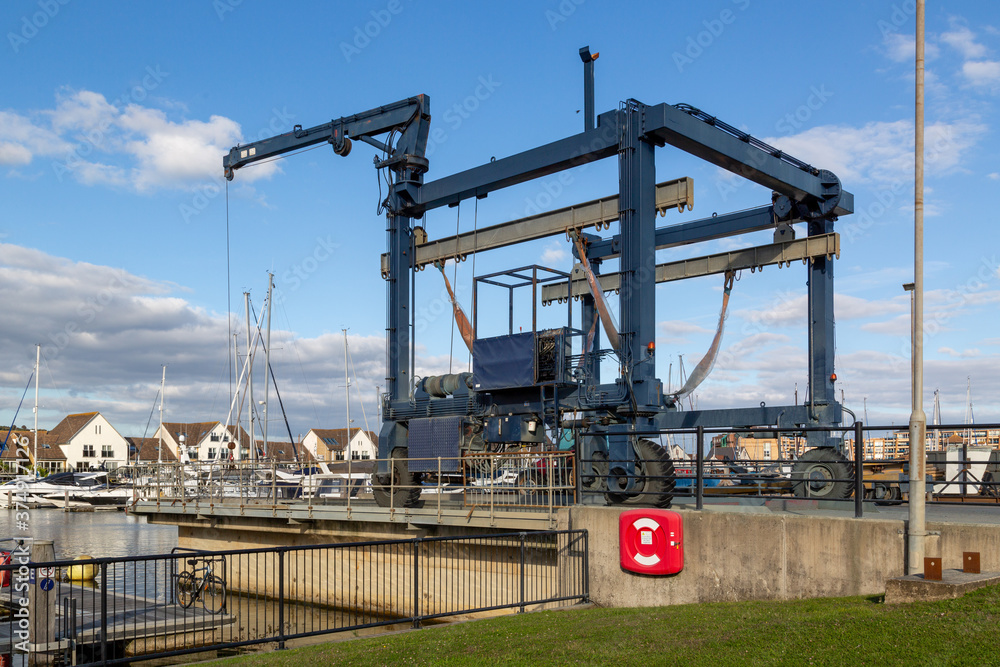 a boat crane lift on a marina use for lifting boats out of the water for repairs