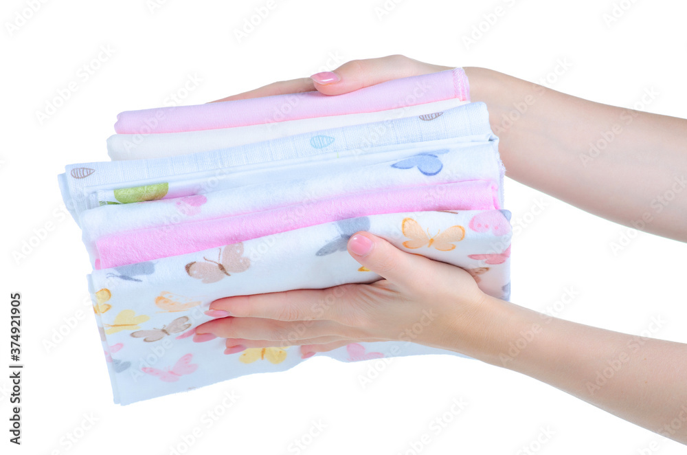 Stack baby cotton diapers in hand on white background isolation