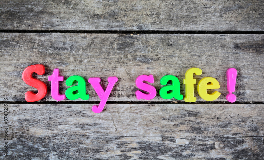 Fototapeta premium Stay safe words on a wooden table