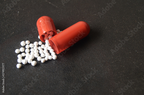 single pill open close up, red pill close up, active ingredient in medicine pill