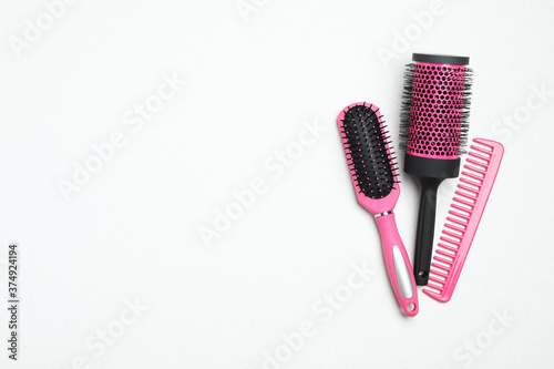 Modern hair comb and brushes on white background  flat lay. Space for text