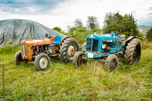 Old tractors parked in the field.