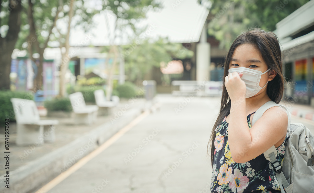 Back to school. asian child girl wearing face mask with backpack going to school .Covid-19 coronavirus pandemic.New normal lifestyle.Education concept. Back to school. asian child girl wearing face mask with backpack going to school .Covid-19 coronavirus pandemic.New normal lifestyle.Education concept.