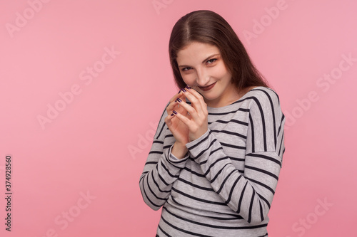 Print op canvas Portrait of devious sneaky playful woman in striped sweatshirt looking with greed, cunning sly smile, conspiring evil plan of revenge, clever scheming
