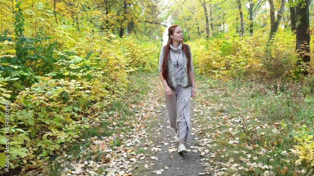 glamorous woman in autumn Park with yellow leaves in hand glamorous woman in autumn Park with yellow leaves in hand