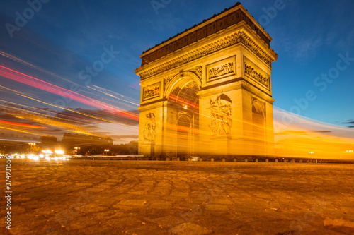 The night view of triumphal arch and traffic in Paris, France. © Zimu