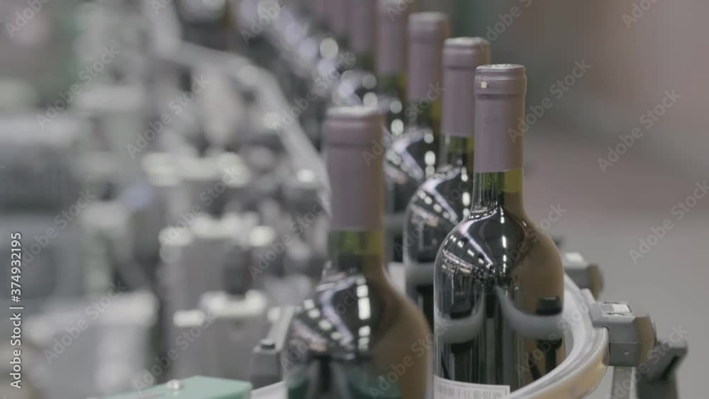 Factory for wine production. Wine factory. Bottles on the bar for filling wine Factory for wine production. Wine factory. Bottles on the bar for filling wine