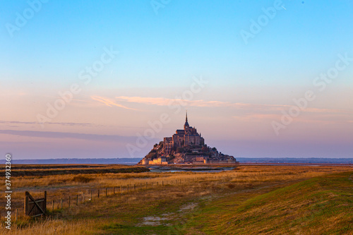 Mont-Saint-Michel and its Bay at sunset, in Normandy, France.