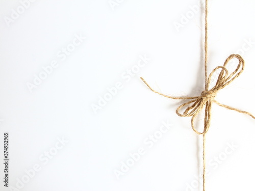Handmade bow made of natural jute rope at the right side - decoration for wrapping gifts