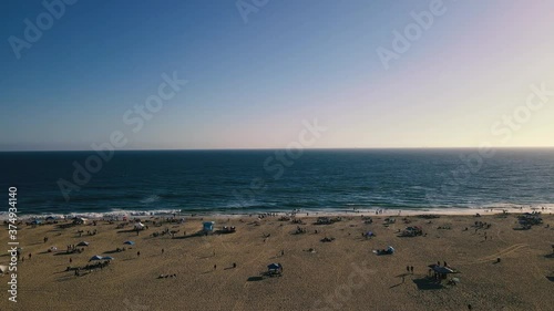 Wallpaper Mural A Slow Aerial Dolly shot of Huntington Beach, California on a mildly busy day with people moving around and in the water. Torontodigital.ca