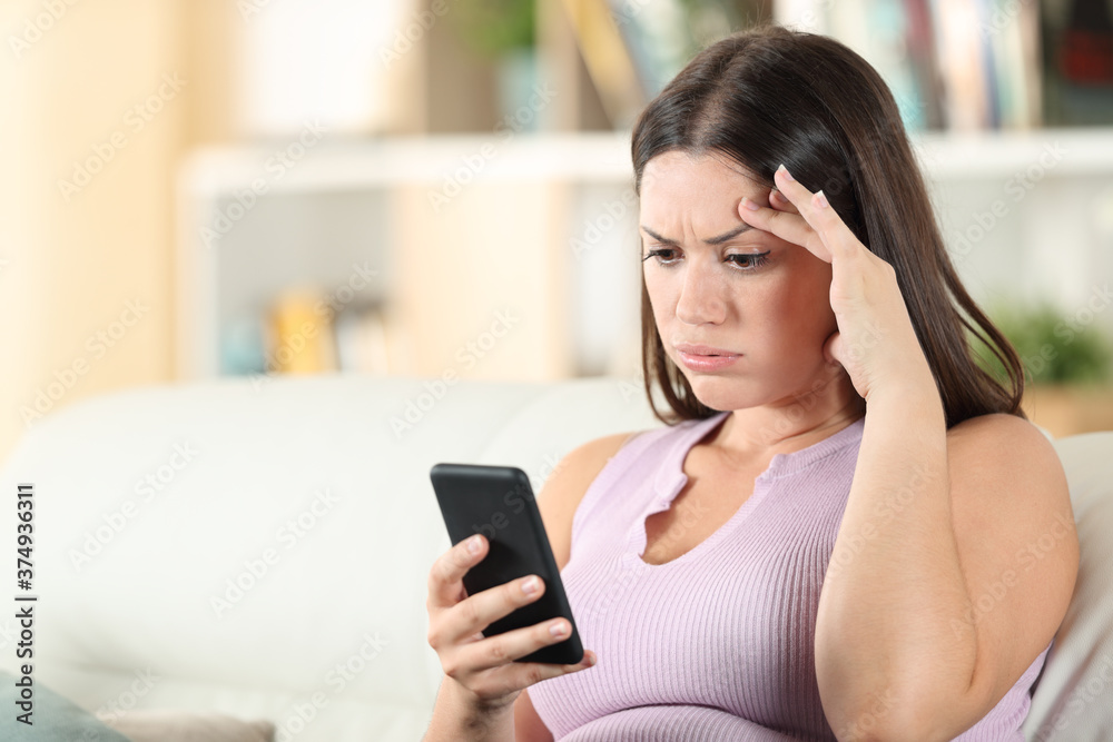 Frustrated woman checking phone finding mistake