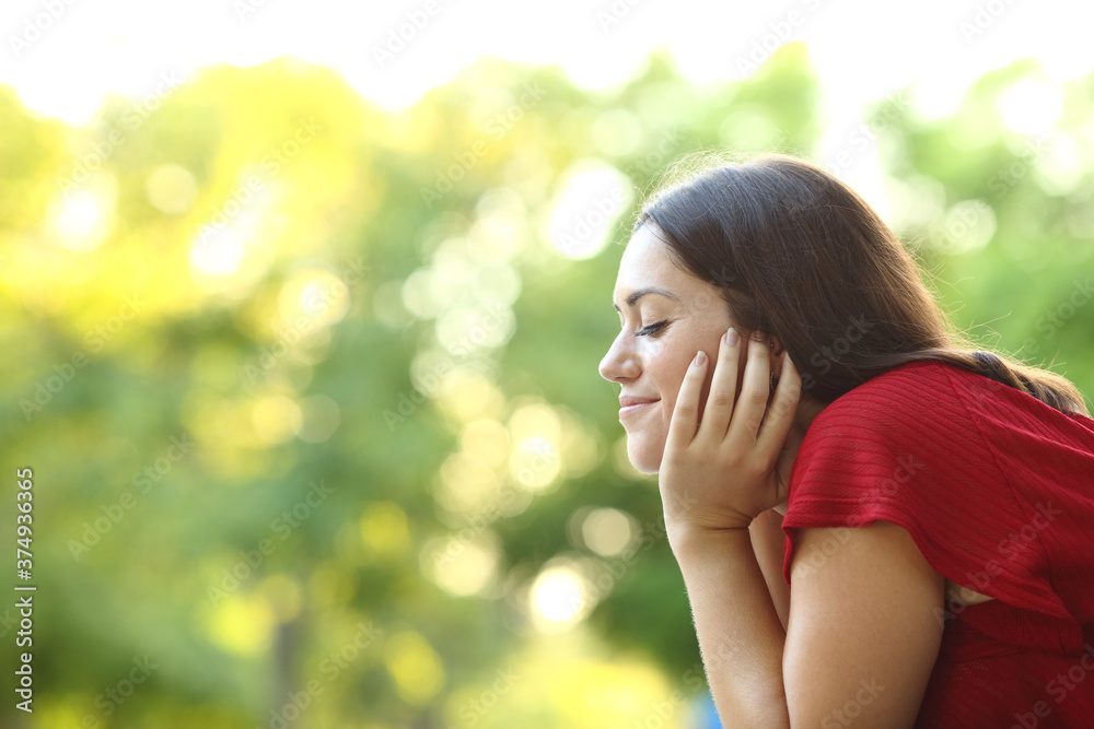 Relaxed woman meditating with closed eyes in a park Relaxed woman meditating with closed eyes in a park