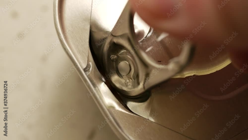 Opening can of cod liver. Man hand open metallic tin lid with canned ...