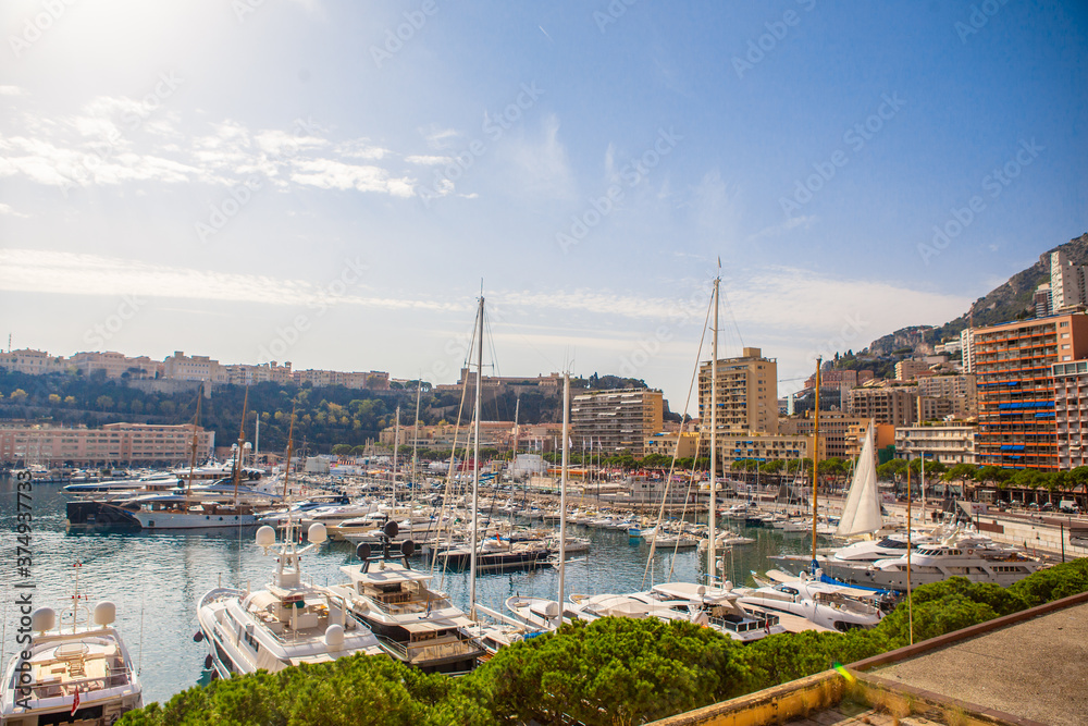 The coastal view of the port and boats in Monaco, on a sunny day.