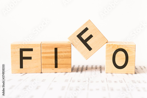 Word fifo. Wooden small cubes with letters isolated on white background with copy space available.Business and finance concept photo