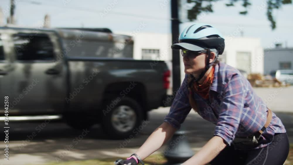 A woman biking on a street A woman biking on a street
