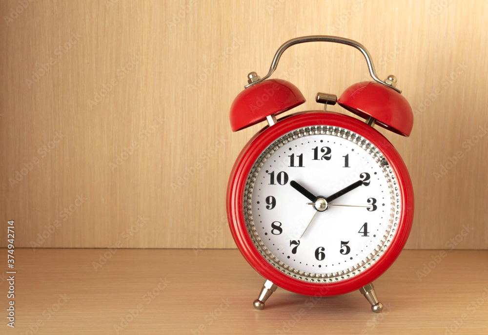 Red alarm clock on shelf Red alarm clock on shelf