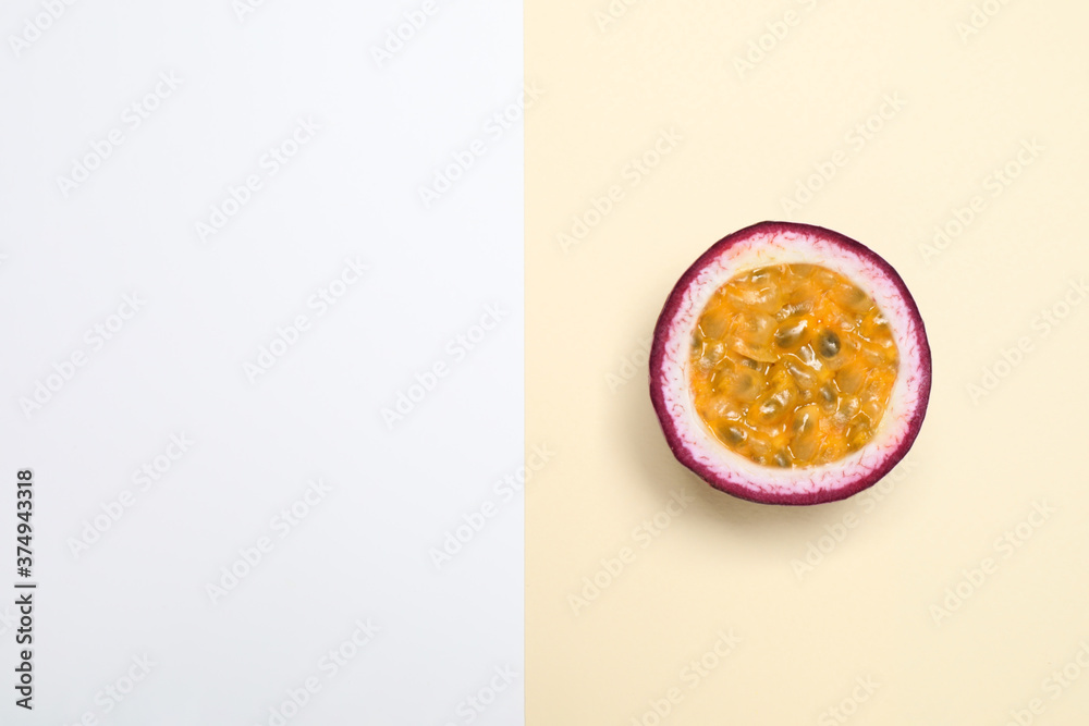 Half of tasty fresh passion fruit (maracuya) on color background, top view. Space for text Half of tasty fresh passion fruit (maracuya) on color background, top view. Space for text