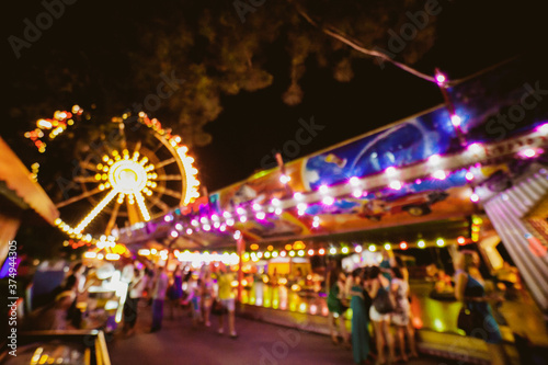 Fényképezés Children's Carousel at an amusement park in the evening and night illumination