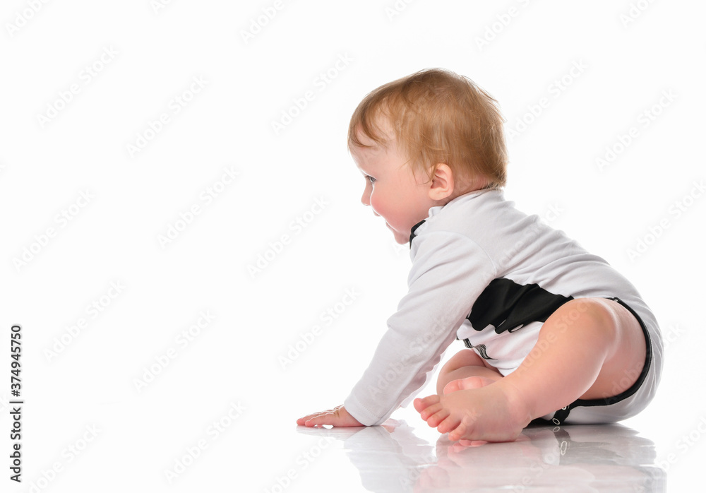 Crawling baby child in jumpsuit studio portrait Crawling baby child in jumpsuit studio portrait