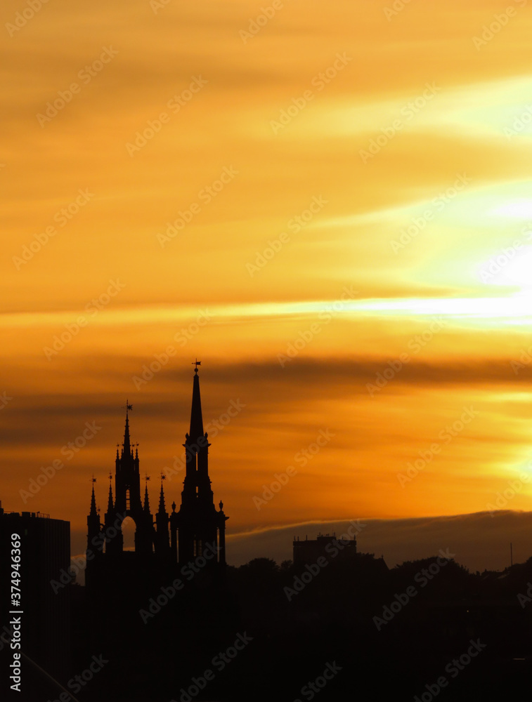Naklejka premium Cathedral and church forming silhouettes at sunset