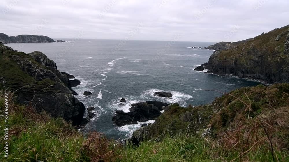 Beautiful high view of cliff and the coast with waves crashing with the rocks